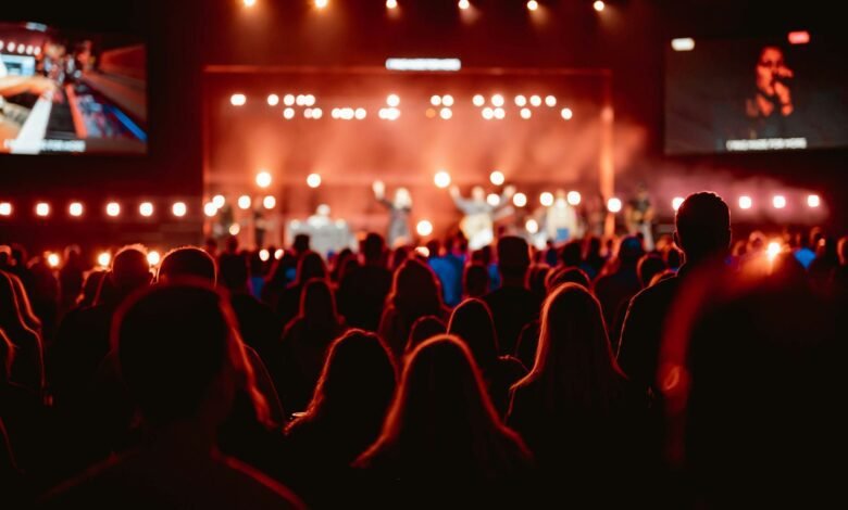 A crowd of people watching a concert on stage